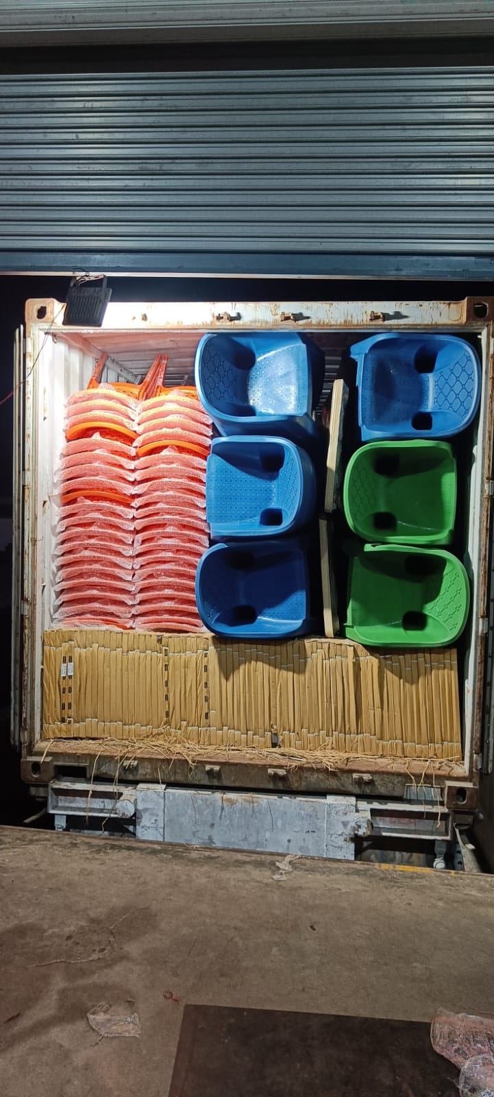 Stackable plastic chairs and storage tubs loaded for export