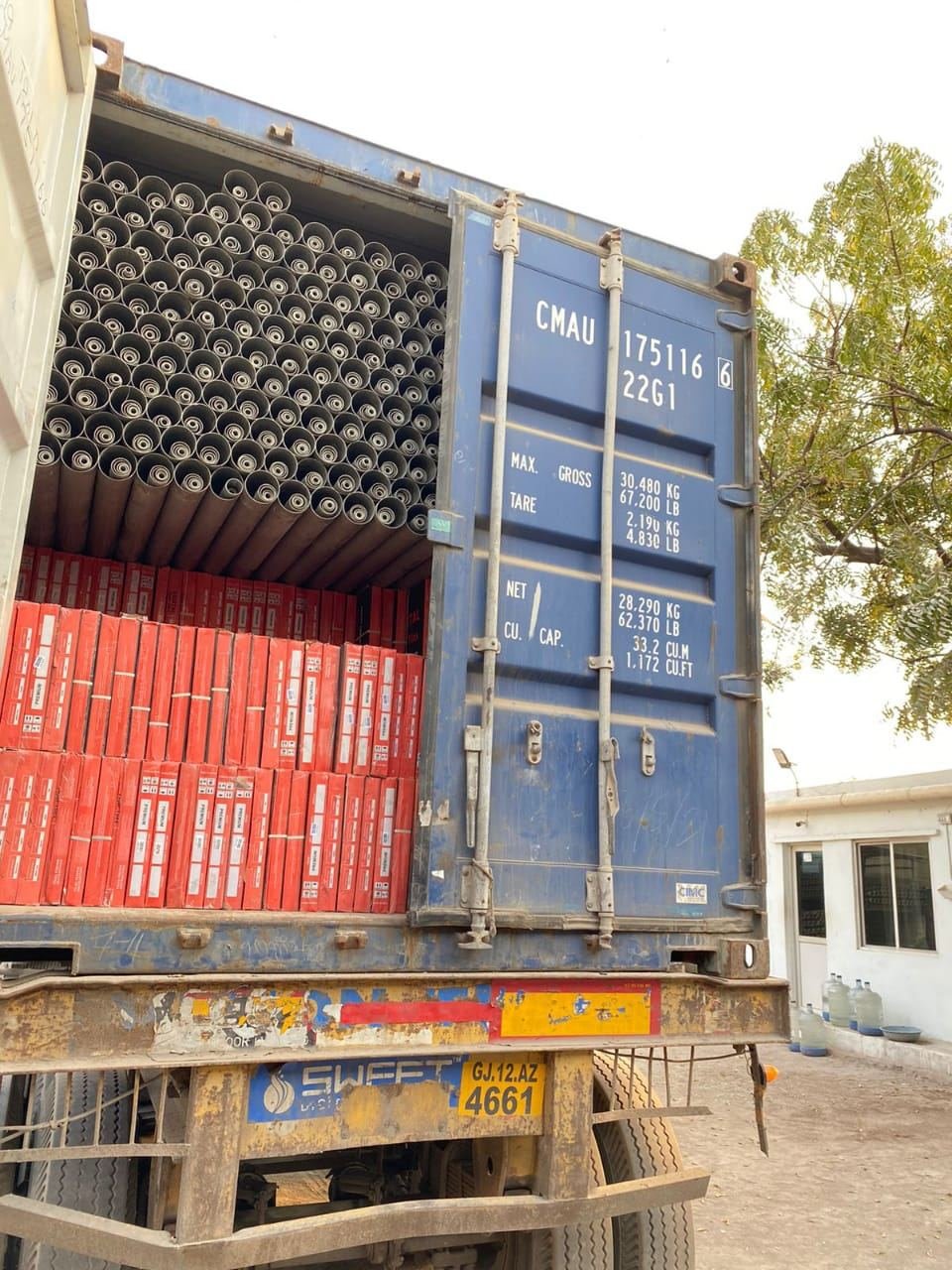 PVC pipe bundles and cartons in a sealed export container