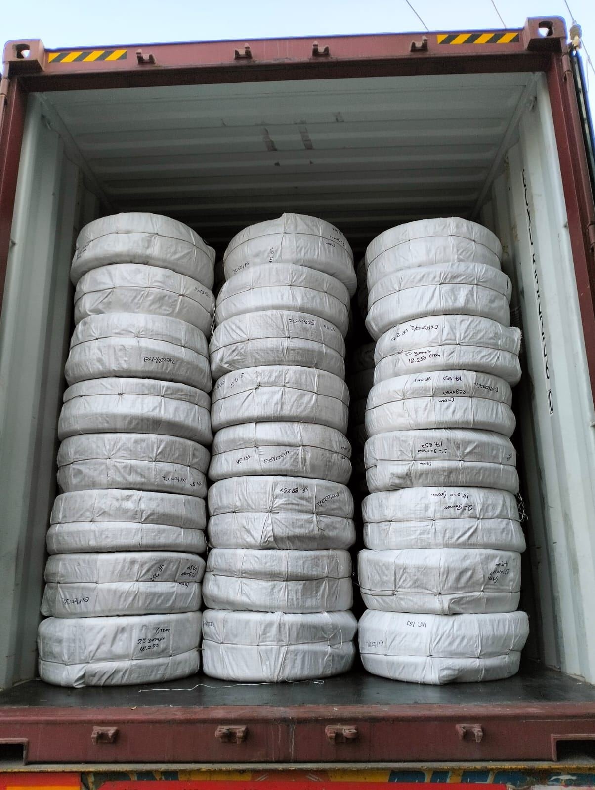 Woven fabric bales wrapped and stacked for export